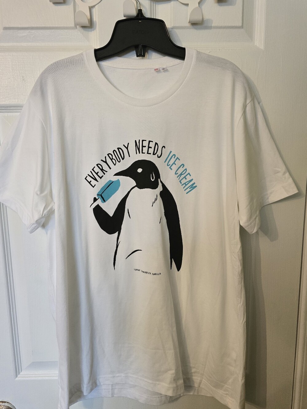 Uniqlo White Penguin Graphic Tee with Blue Accent